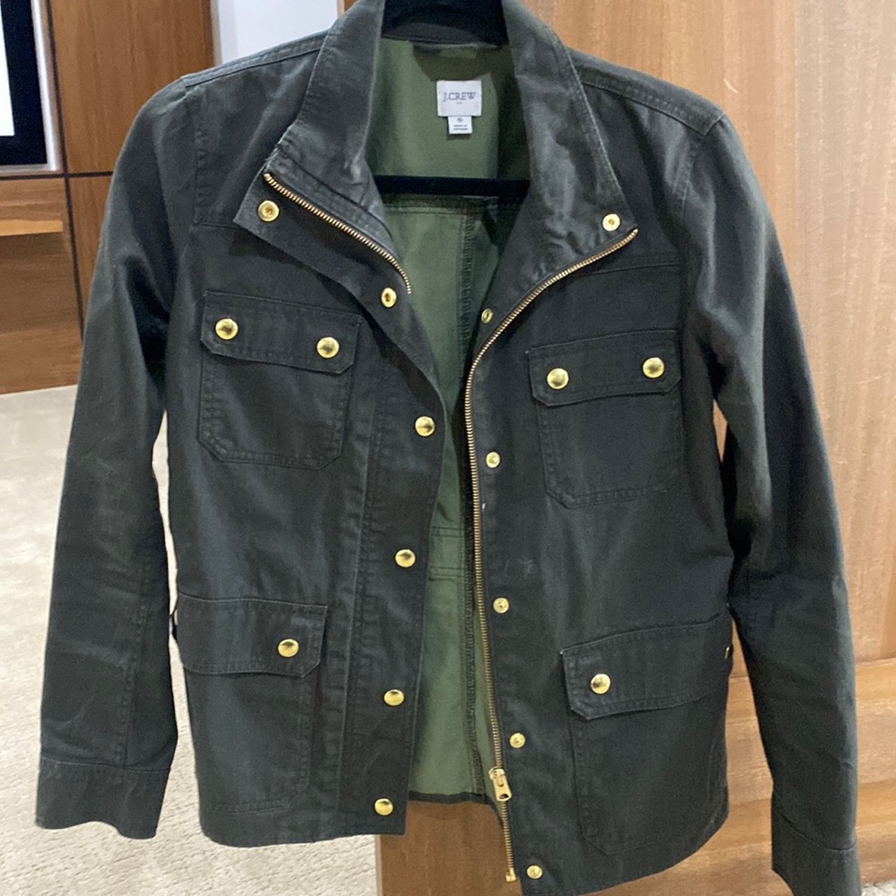 Olive green jacket with gold details .